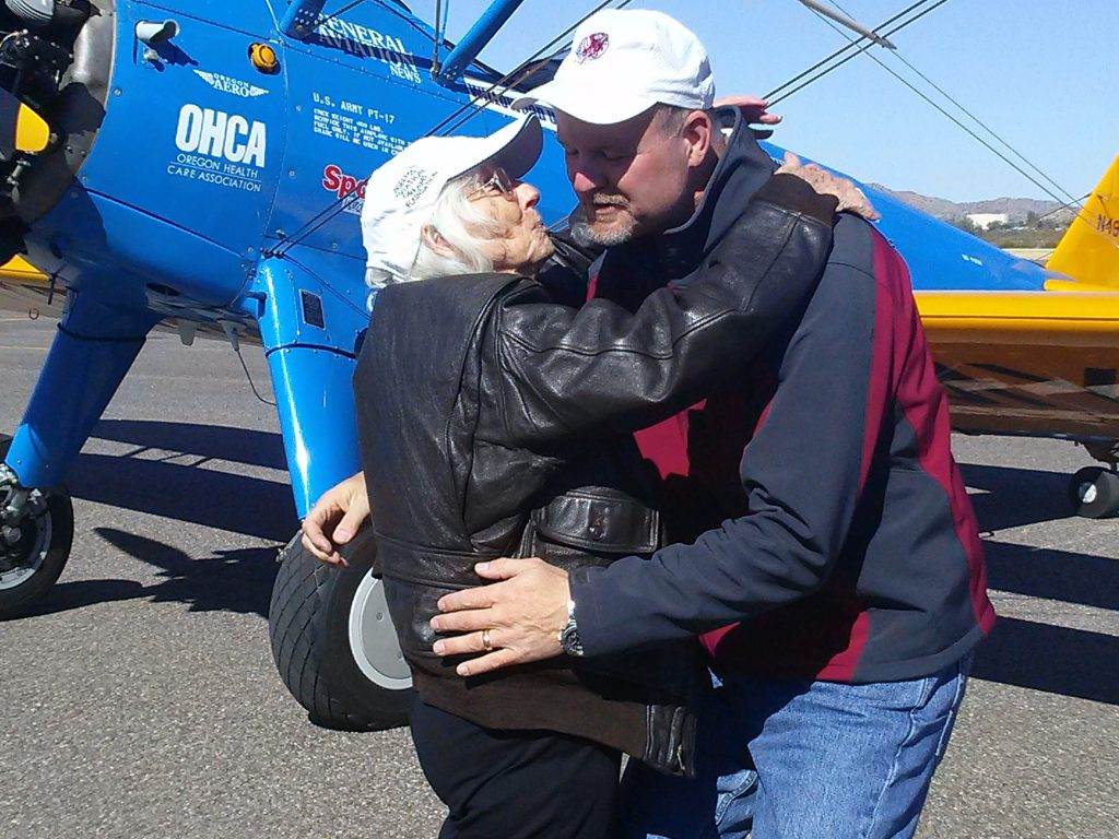 Irene gives her pilot, name, a big kiss of gratitude.