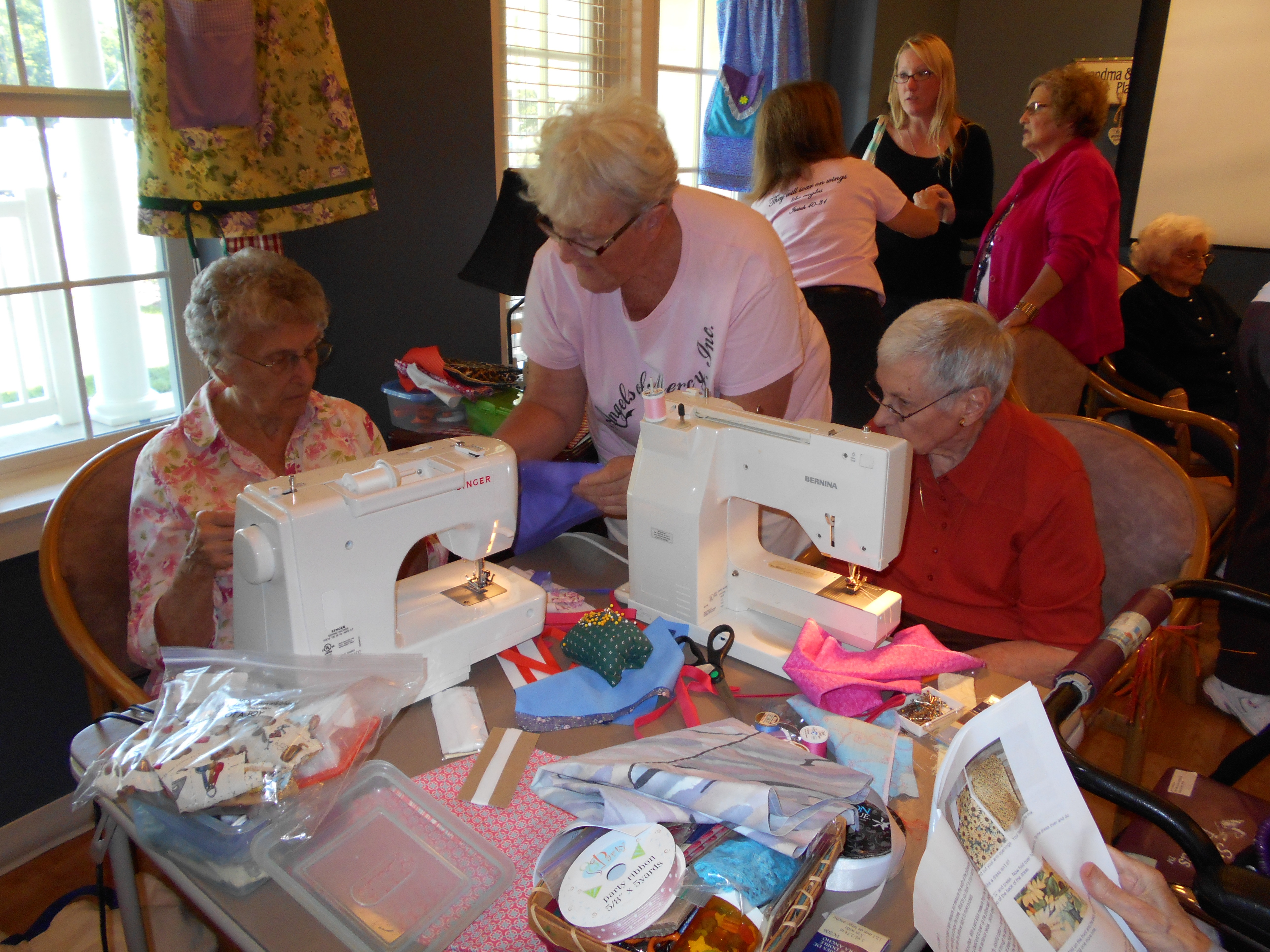 Ruth and Margaret sew dresses to be donated to the Dress a Girl Around the World program.