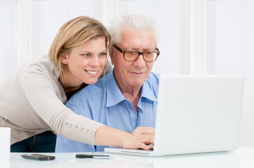 woman helping father with computer