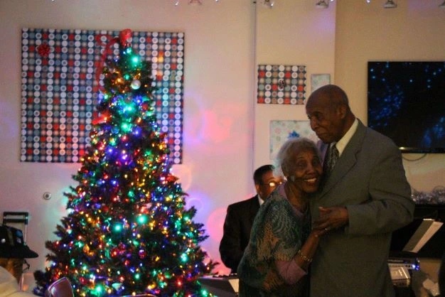 Bertha dances with her husband Henry at the Holiday Ball.