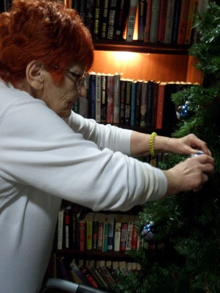 senior decorating christmas tree