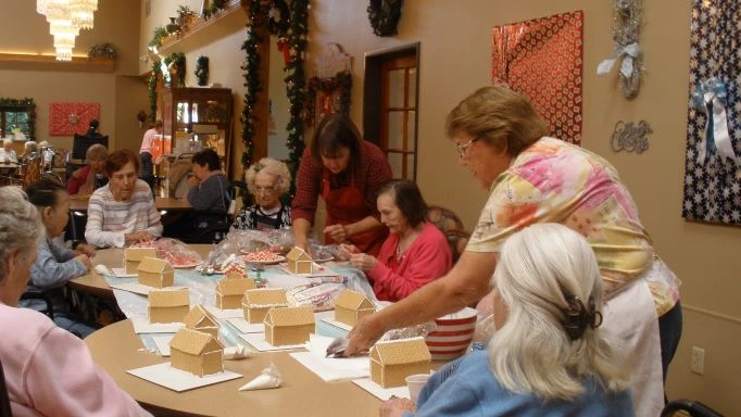 seniors making gingerbread houses