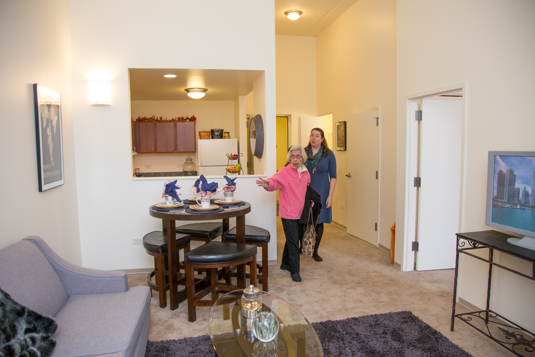 Soon-to-be-resident Luz Capito is shown an apartment model by Carolyn Jaksic.