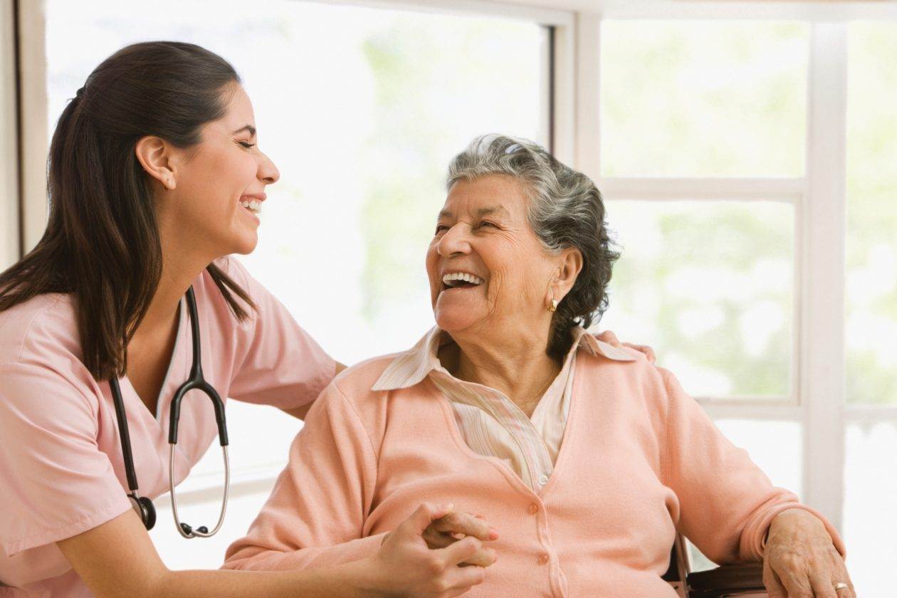 senior lady smiling with caregiver