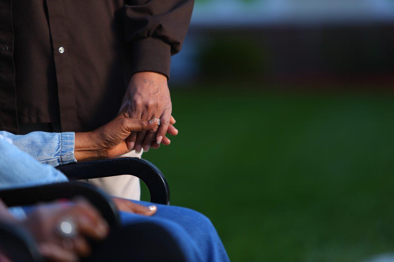 man holding woman's hands