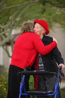 women hugging and smiling