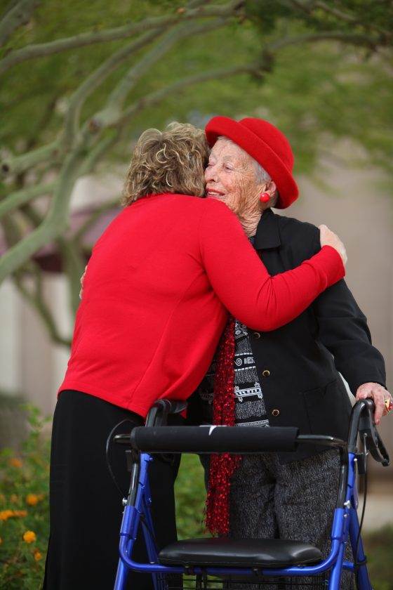 women hugging and smiling