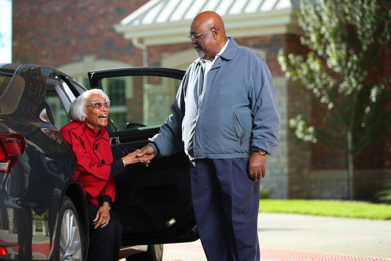 helping wife out of car