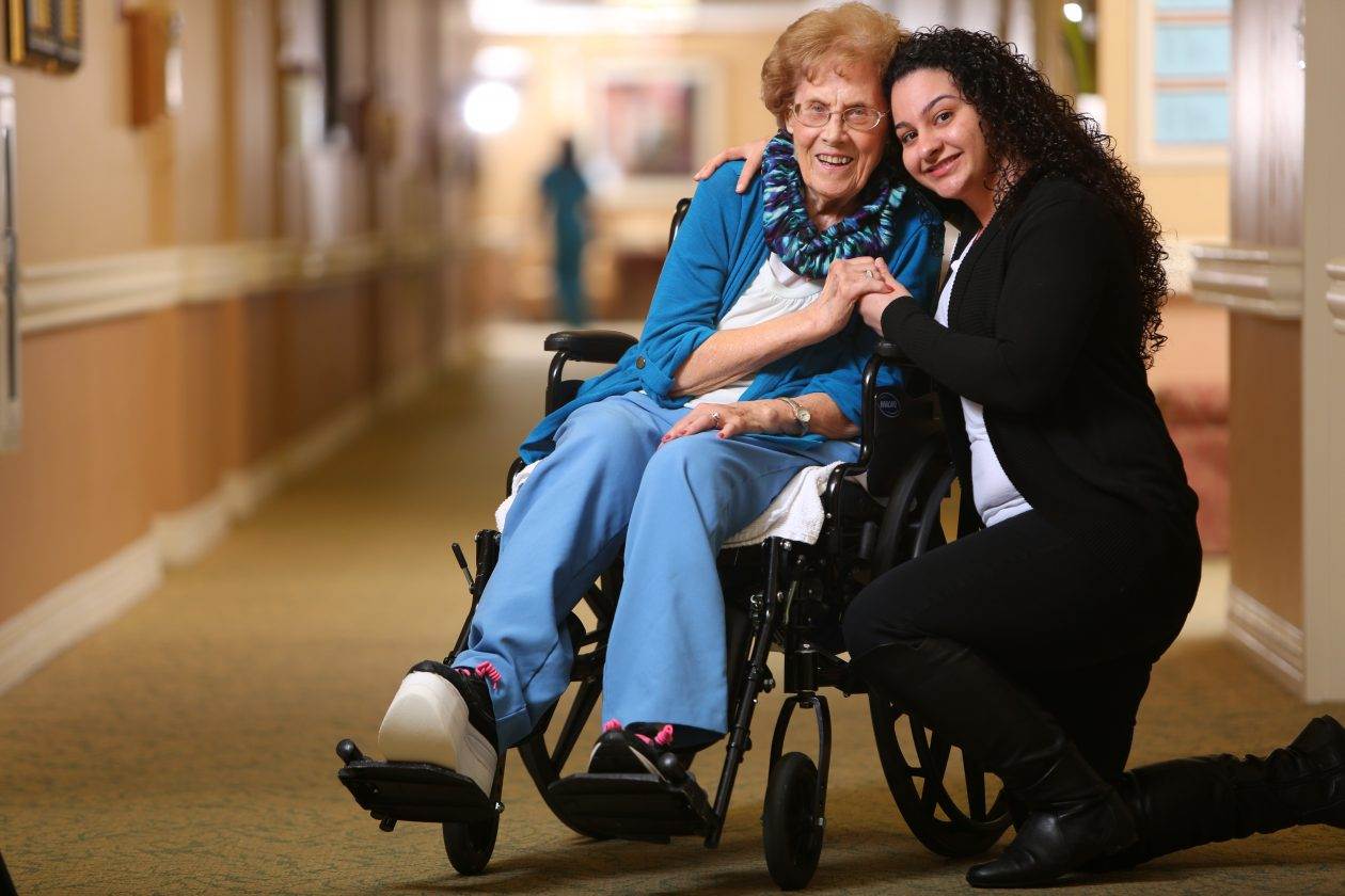 women hugging in wheelchair