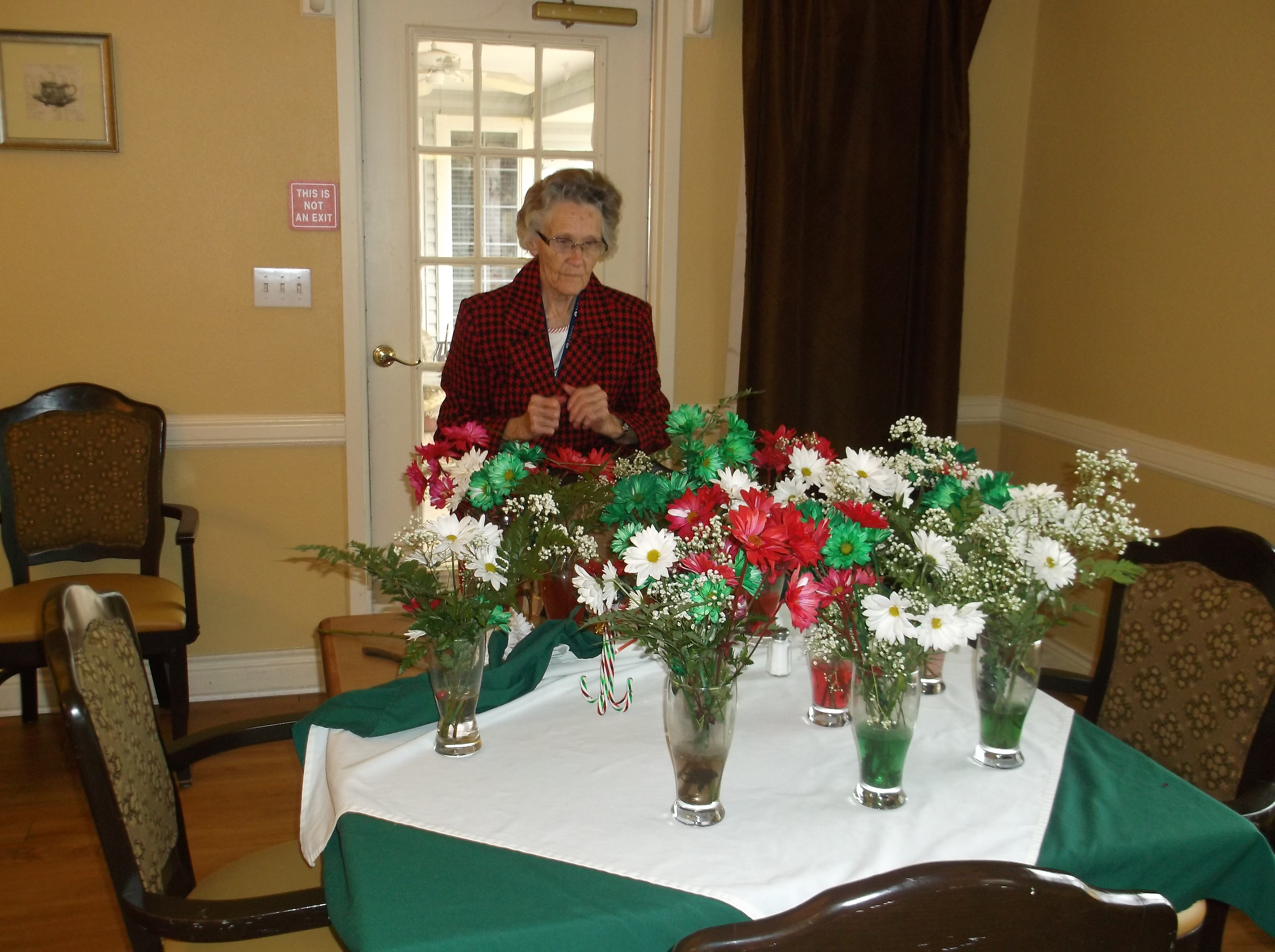 Anita arranges flowers for the night's party.