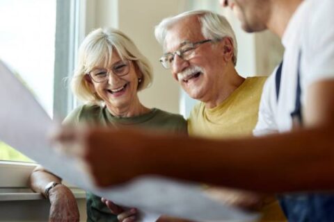 Happy senior couple touring apartments at a senior living community.