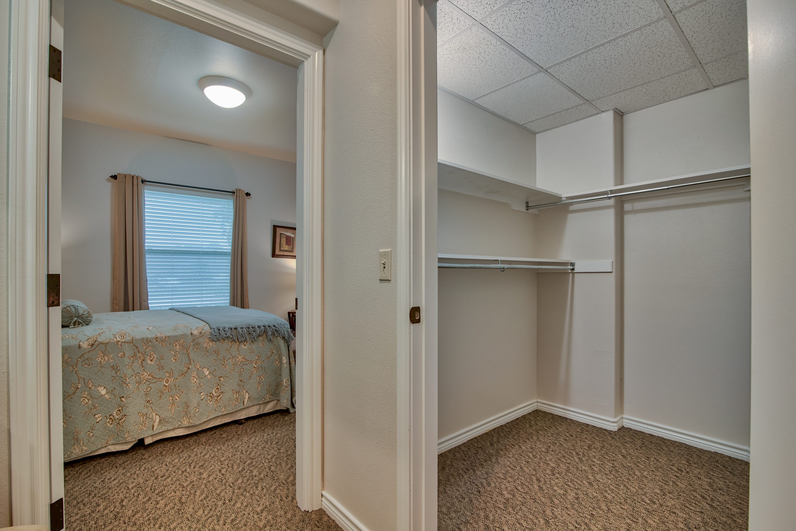 Pelican bay assisted living memory care community walk in closet and bedroom