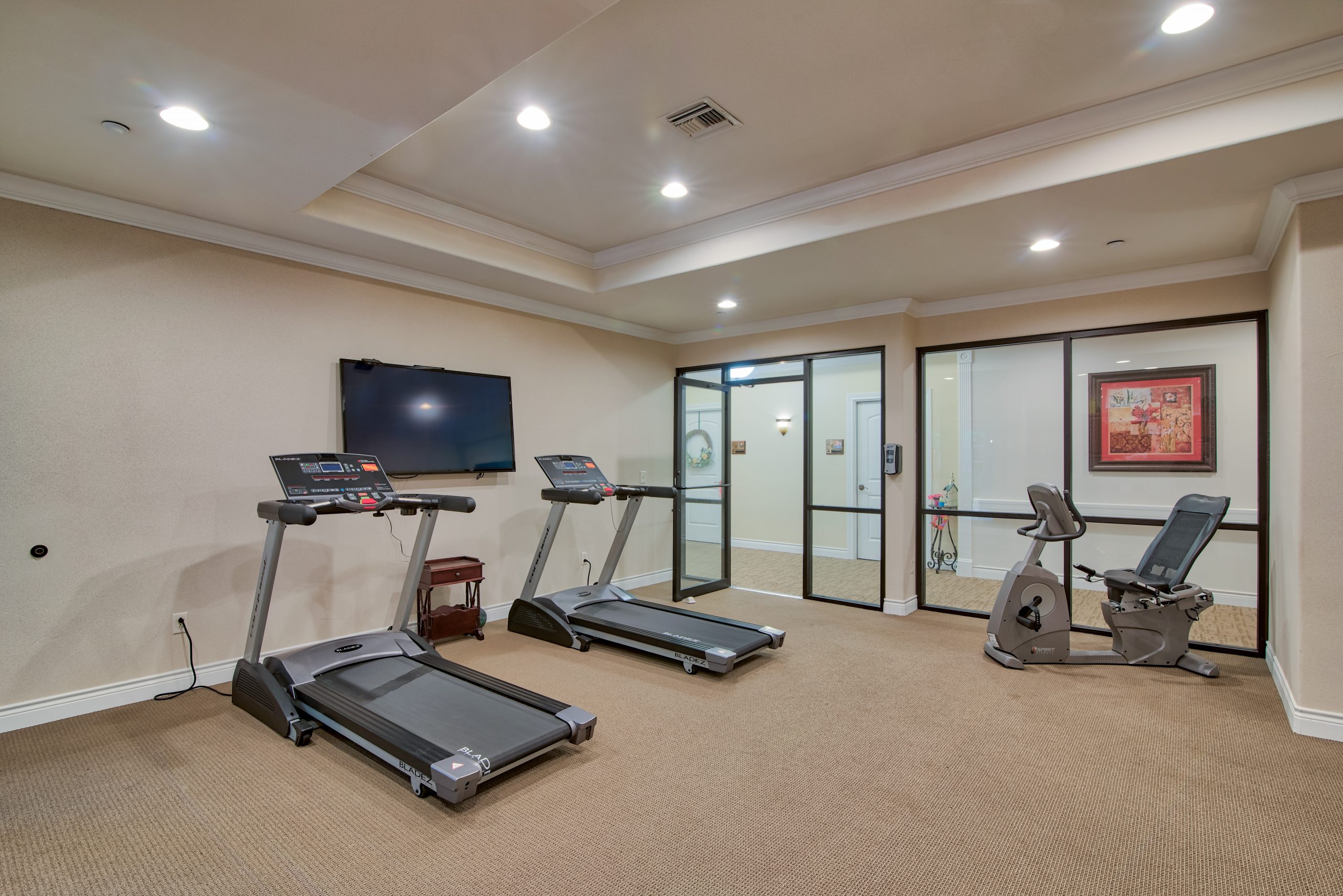 Pelican bay assisted living memory care community treadmills in fitness room