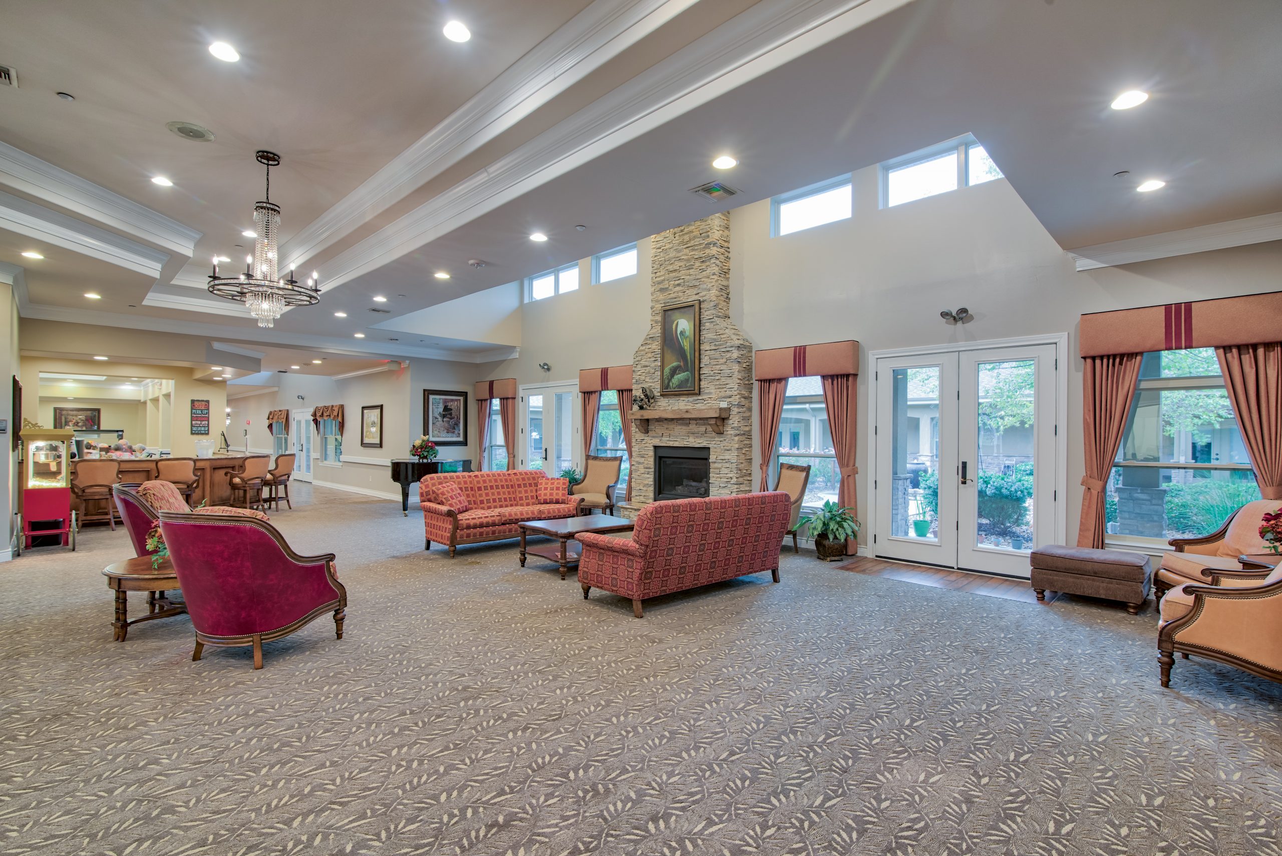 Pelican bay assisted living memory care community open living area with couches