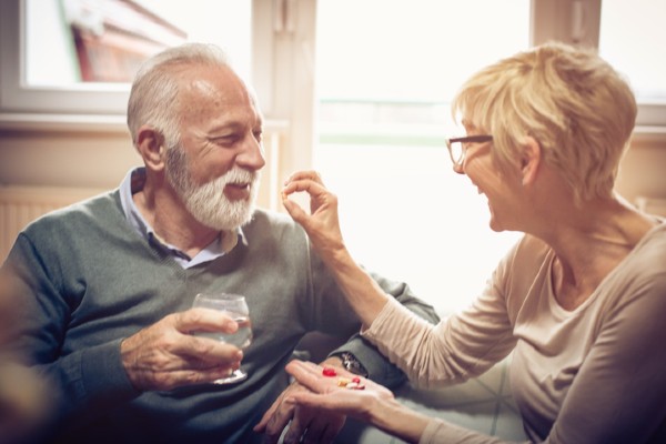 Senior couple taking vitamins