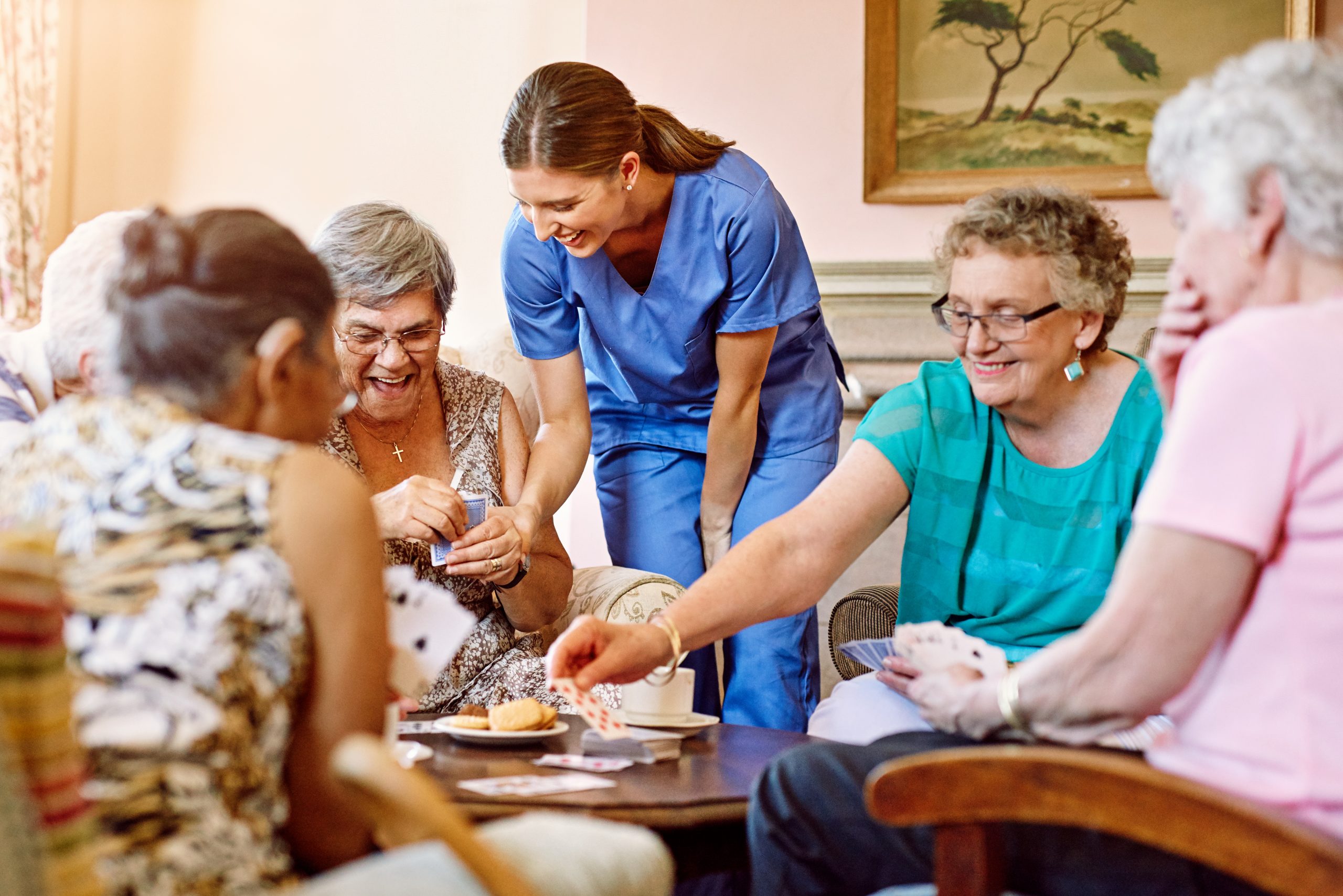 Nurse-laughing-with-group-of-senior-laides-1