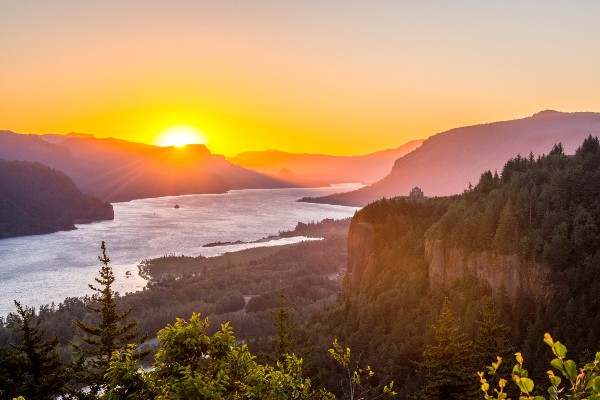 Crown Point at the Columbia River Gorge in Oregon is bathed in the light of sunrise.