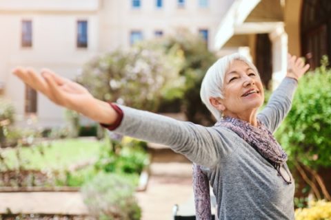 A senior woman enjoys her surroundings at a senior community.