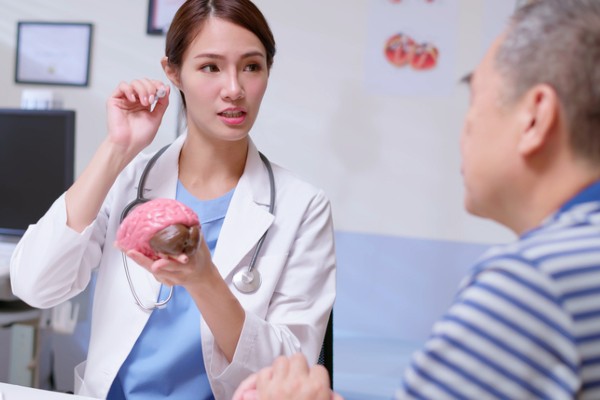 A doctor explains vascular dementia to an elderly patient.