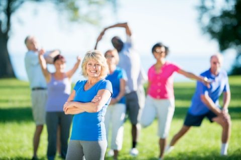 Seniors stretch along Lake Ontario before a run.