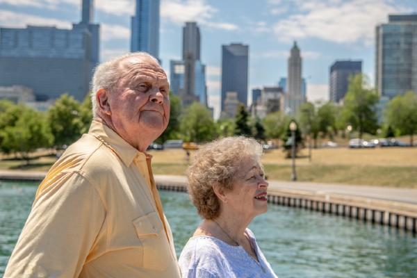 A senior couple in independent living explore the shore along the lake in Chicago.