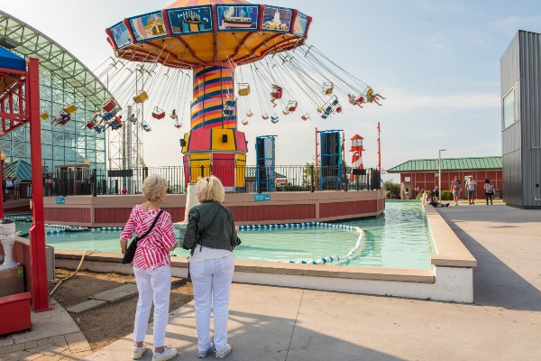 Senior women watch their grandchildren on a ride at the Navy Pier in Chicago.