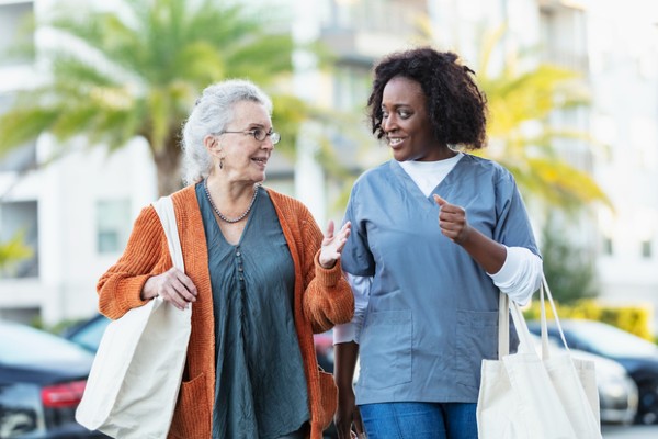 A senior goes shopping with her caregiver.