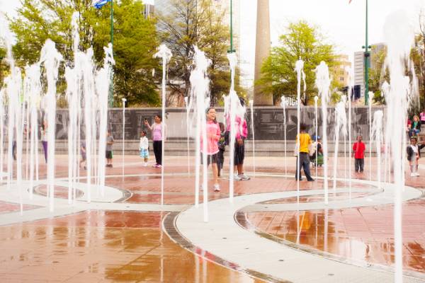 Families play at the Centennial Olympic Park fountain in downtown Atlanta.