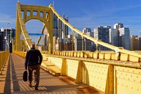 A man walks over a bridge to his job in downtown Pittsburgh.