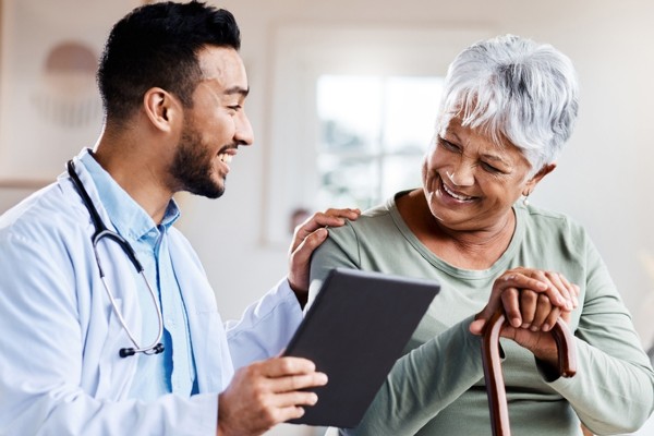 A young doctor shares test results with his senior patient.