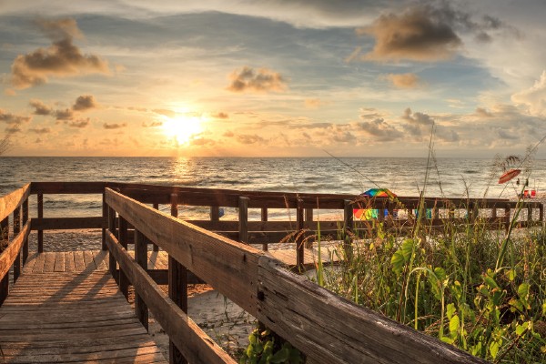 A boardwalk welcomes visitors to Delnor-Wiggins Pass State Park in Naples, FL.