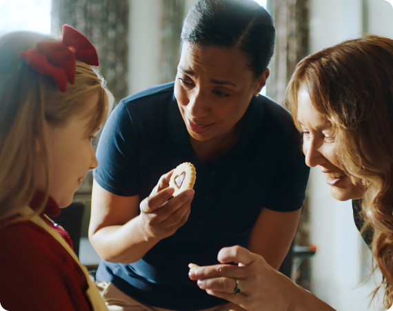 Women teaching child to bake