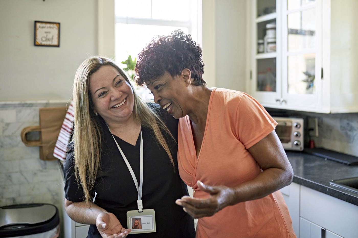 Miami senior woman and home caregiver together in kitchen