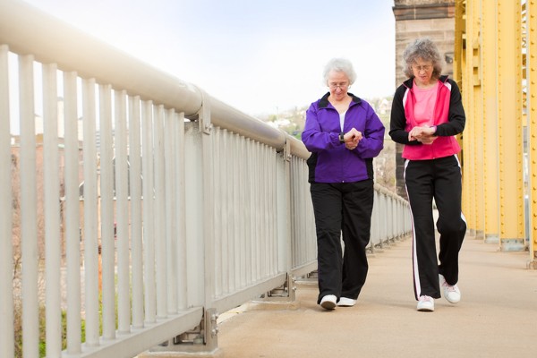 Two senior women walk across a bridge in nearby Pittsburgh.