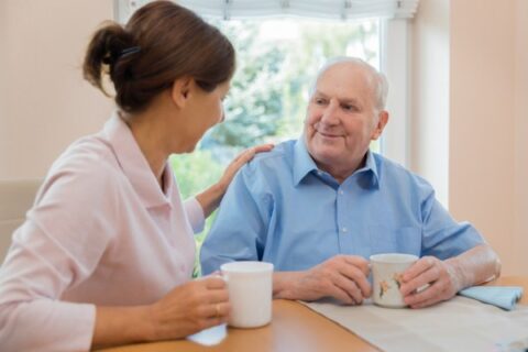 A woman takes care of her father who has dementia.