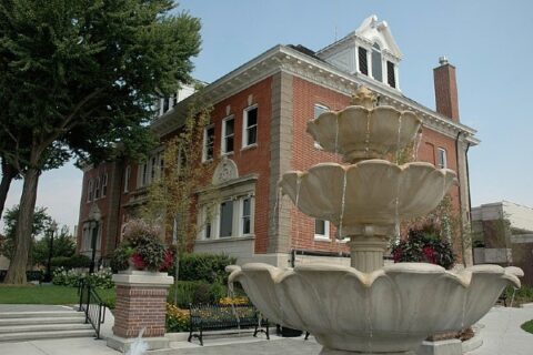 The La Grange Village Hall, with a running fountain in the foreground, stands in Illinois.