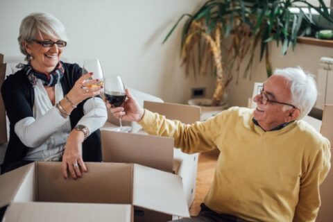 A retired couple toast to their new home.