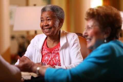 Two senior women enjoy each other's company.
