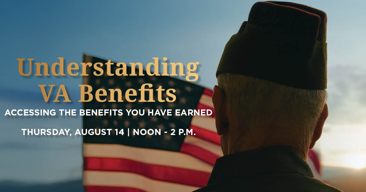 An older veteran standing in front of the American flag.
