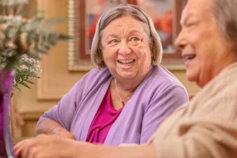 A senior and a friend chat.