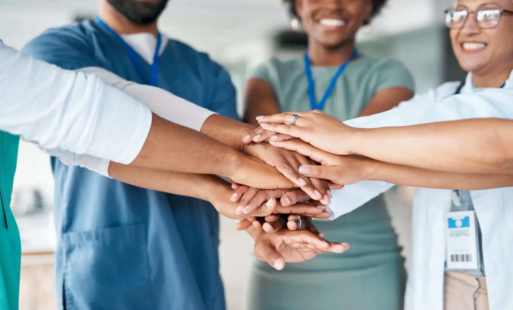 Hands together of doctors and nurses in healthcare teamwork, solidarity and support in hospital diversity. Workflow of medical people, staff or employees in hand stack goal for happy clinic workforce Hands together of doctors and nurses in healthcare teamwork, solidarity and support in hospital diversity. Workflow of medical people, staff or employees in hand stack sign for happy clinic workforce