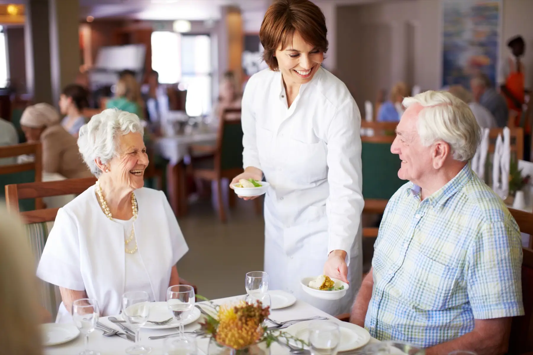 Here you go… Married senior couple enjoying a lunch together while receiving friendly service