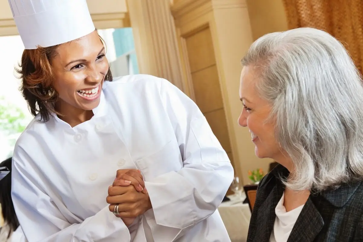 Restaurant chef helping customers order from menu Restaurant chef helping customers order from menu.