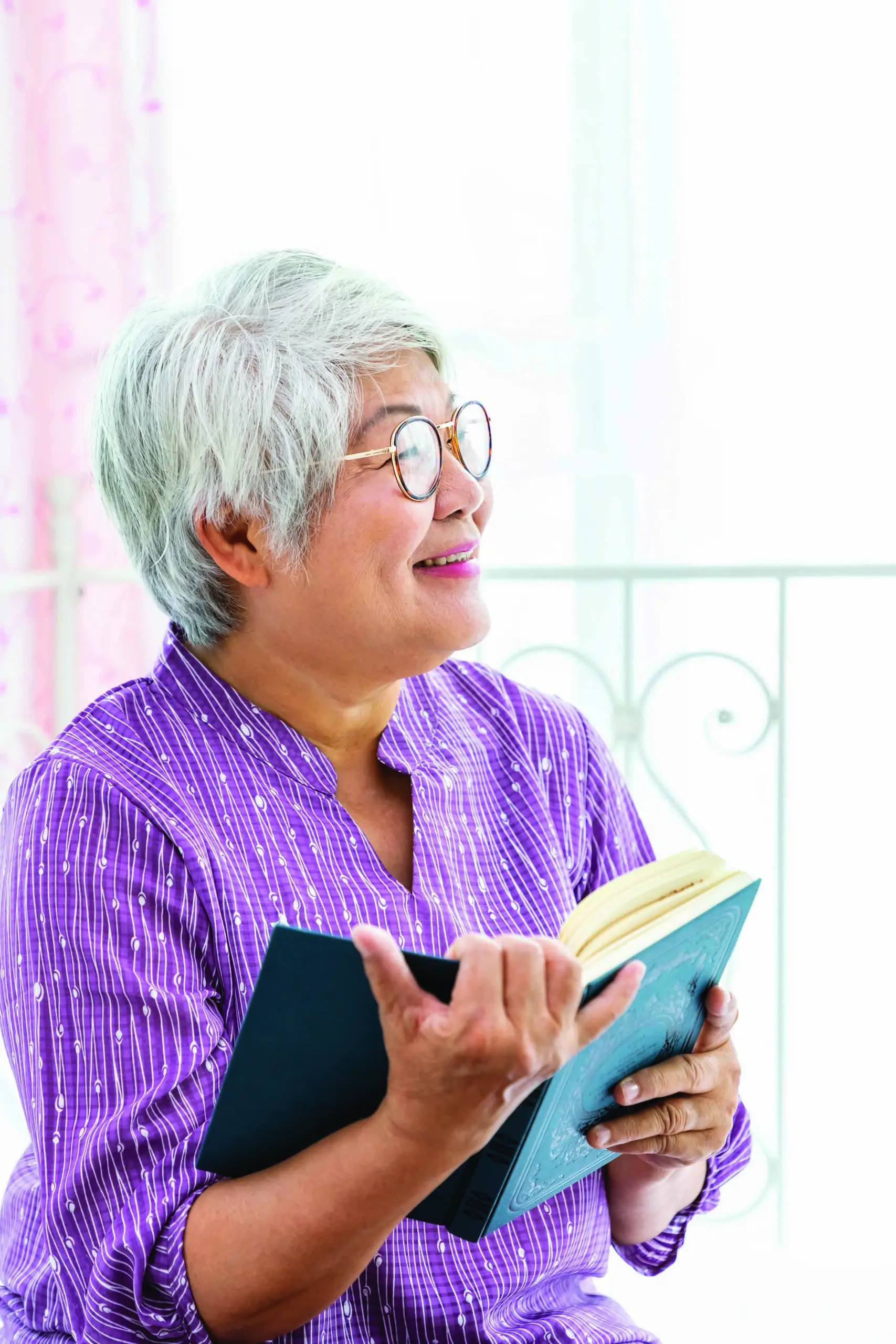 Happy elderly senior woman female lady enjoy reading book