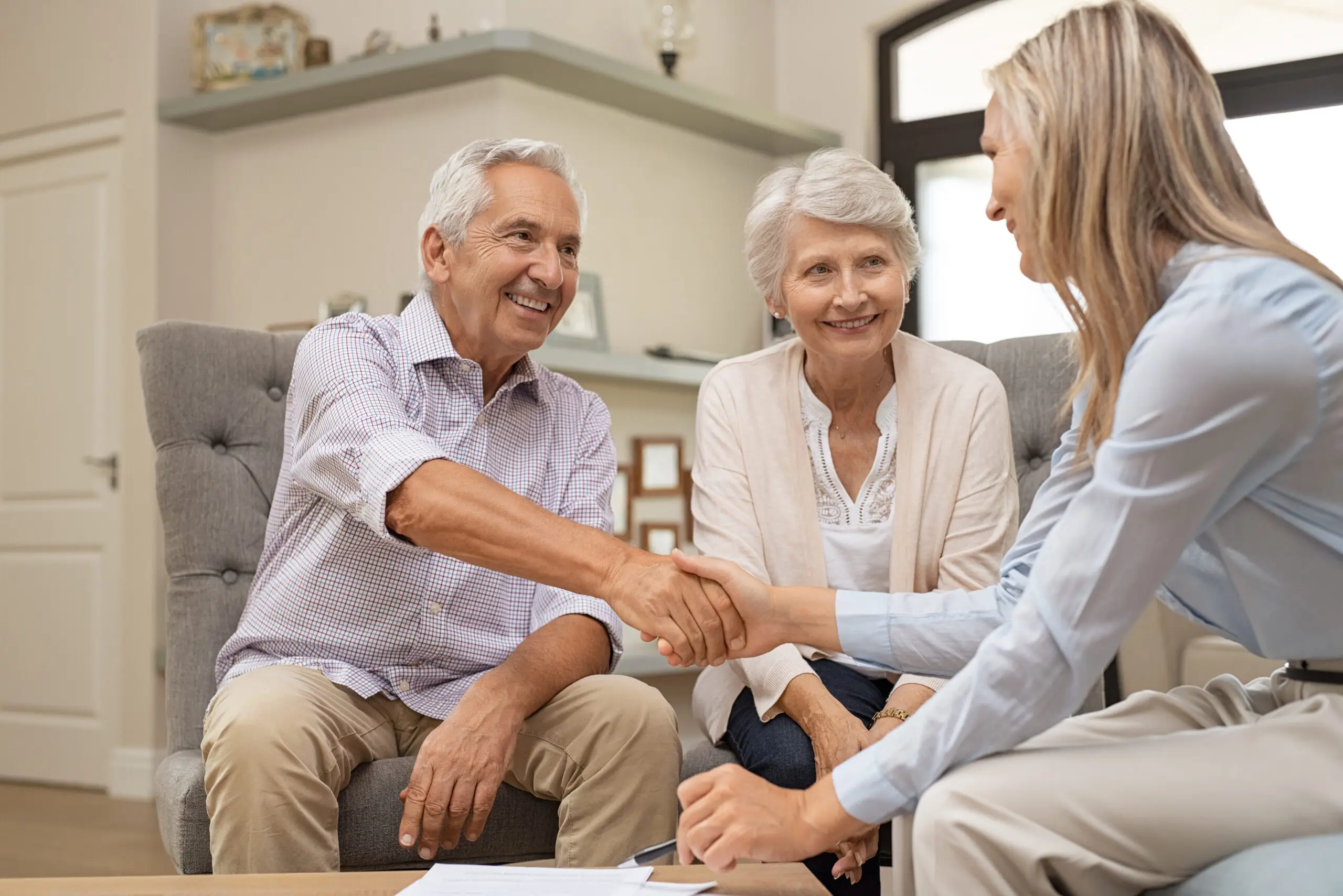 Senior couple shaking hands with financial advisor Senior couple shaking hands with financial advisor