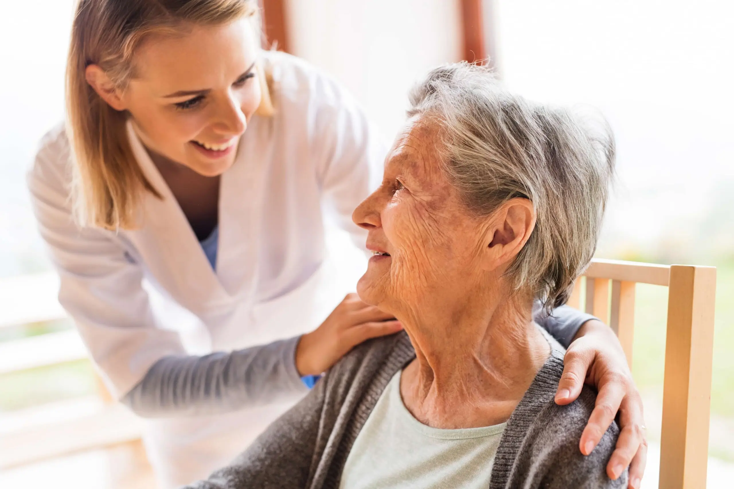 skilled-nursing-health-wellness-nurse-smiling-with-resident-scaled
