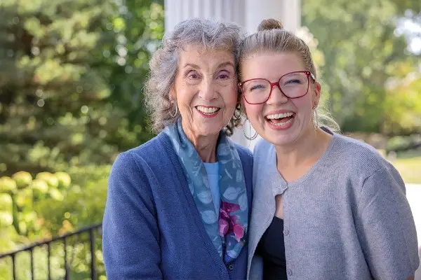 A retiree and her daughter share a smile.