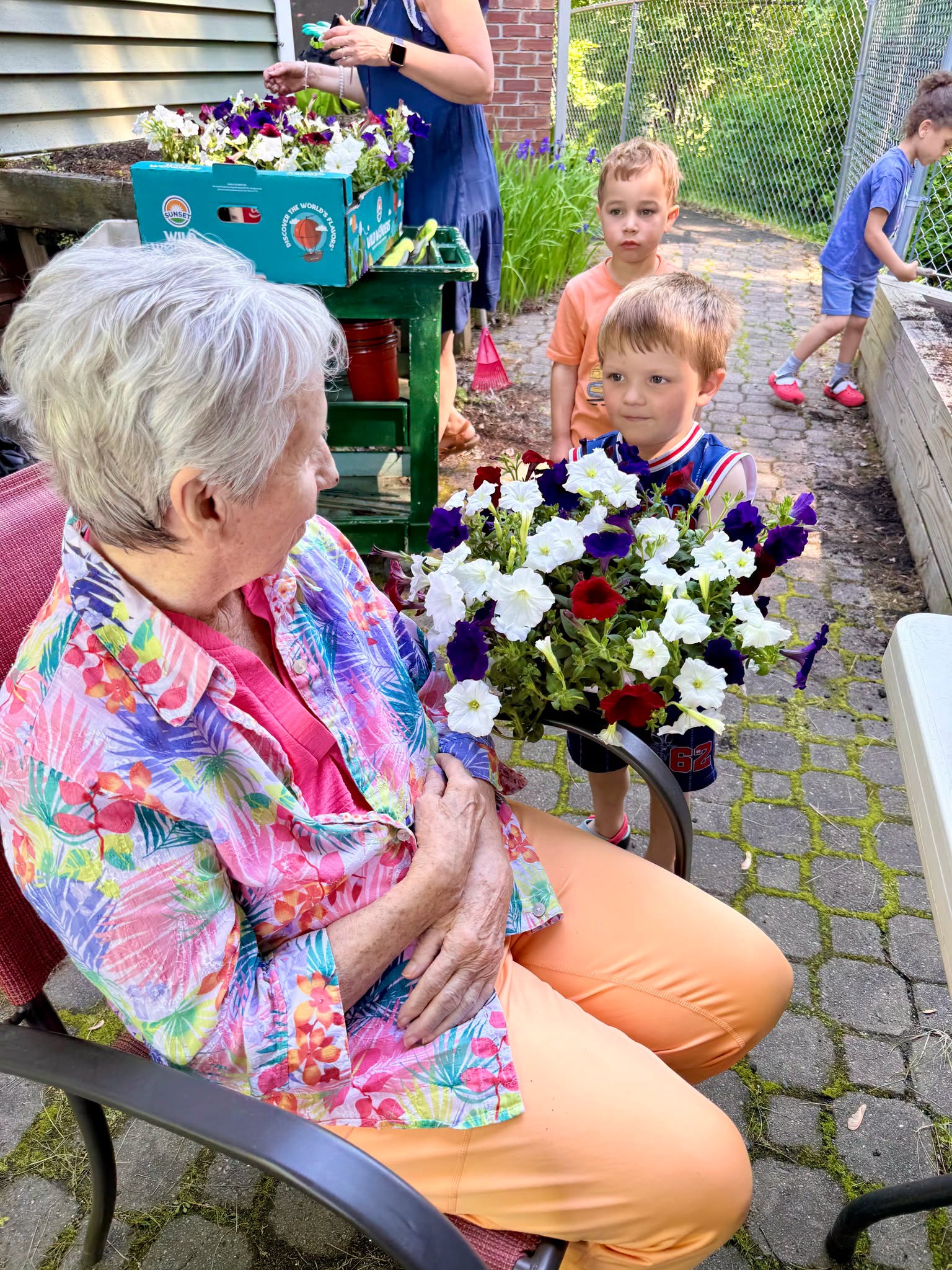 Grandkids offering flowers to grandmother