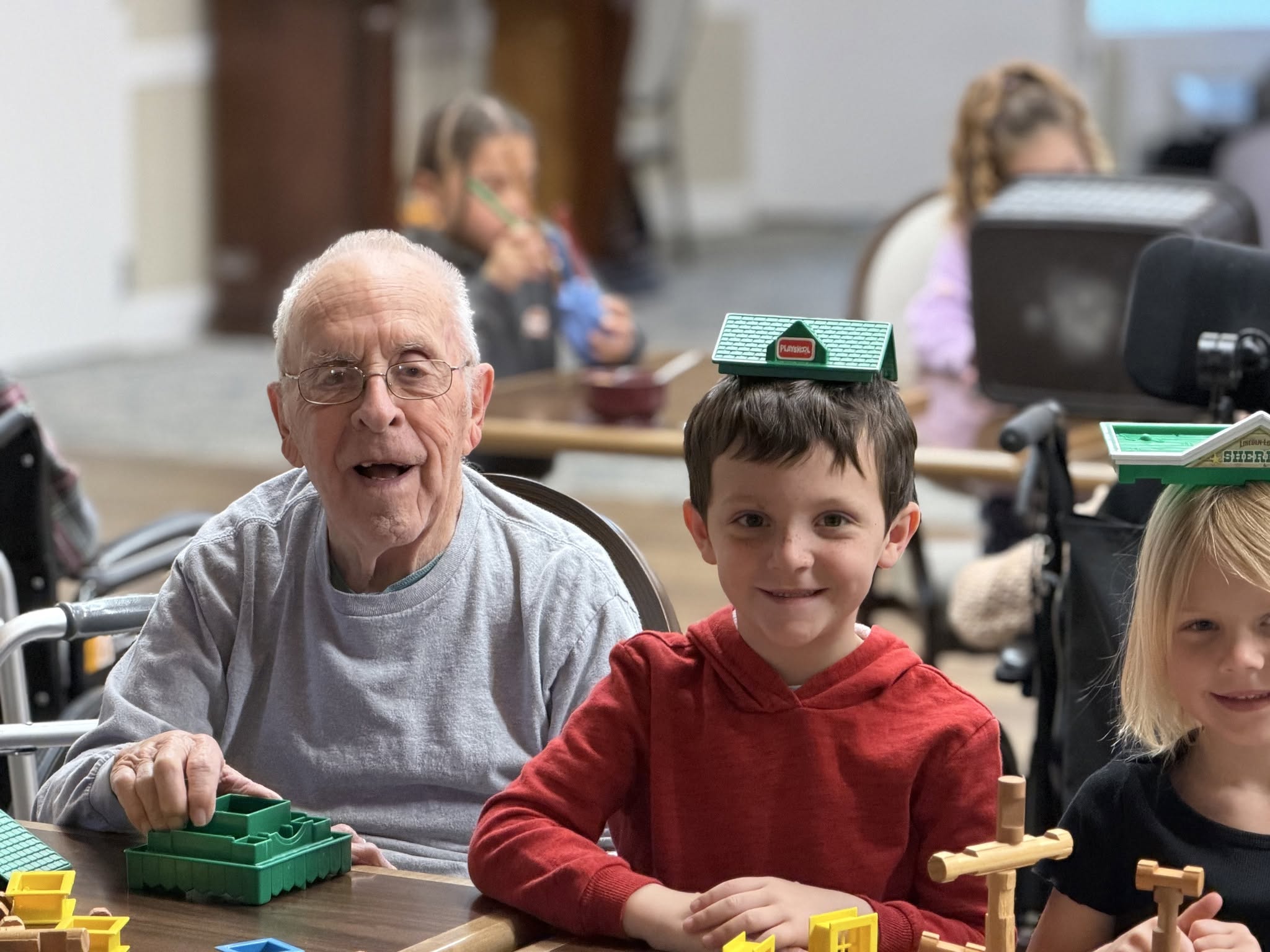Grandparent spending time with grandkids at preschool
